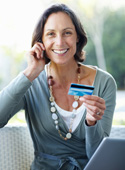 Woman on phone holding a credit/debit card
