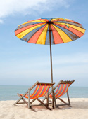 Beach scene with umbrella and chairs